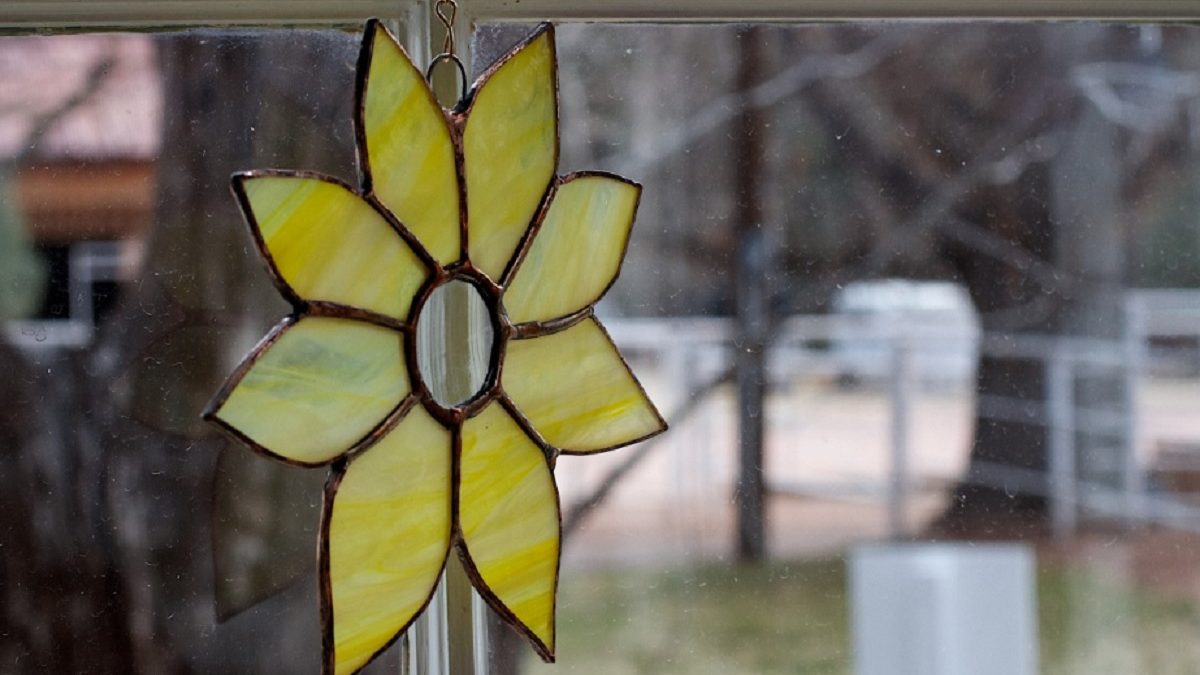 Foto van een gele bloem gemaakt van glas met de techniek tiffany.